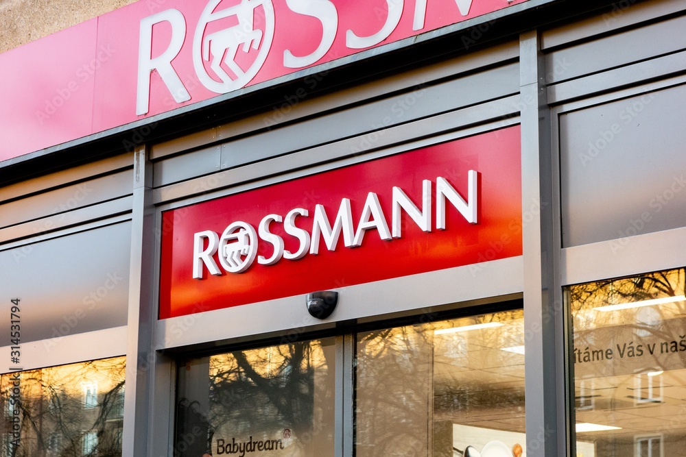 The entrance to the Rossmann drugstore shop in Ostrava with red banner and  logo of the company Stock Photo | Adobe Stock