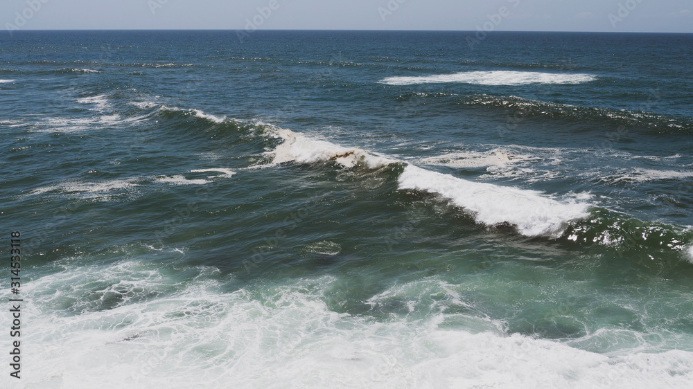 Large ocean waves crashing, on a sunny day. Taken in Portugal.