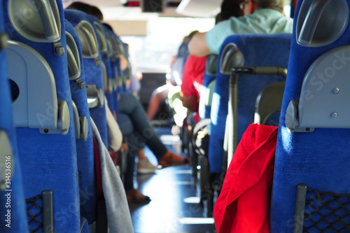 Group of passengers or tourists in travel bus. Transport, tourism, road trip and people concept. People in the intercity bus