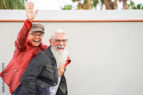 Retired couple playing to be young. Elderly couple having fun. Best elderly friends laughing at the camera. Retired and Young concept – Image photo