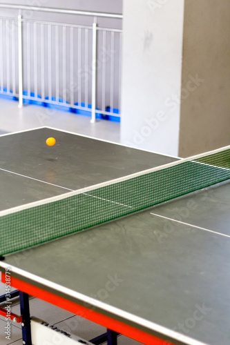 Ball in motion above table tennis table