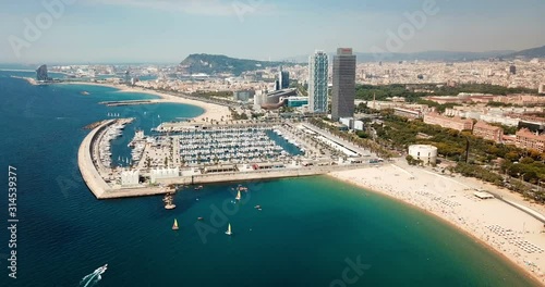 Modern cityscape of Barcelona on background with water surface of Mediterranean photo