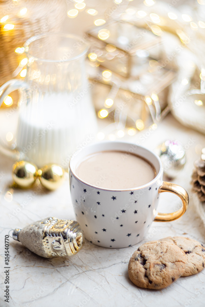 Cozy winter holiday decoration, Christmas lights and coffee cup with decor details, real home Cozy winter holiday decoration, Christmas lights and coffee cup with decor details, real home