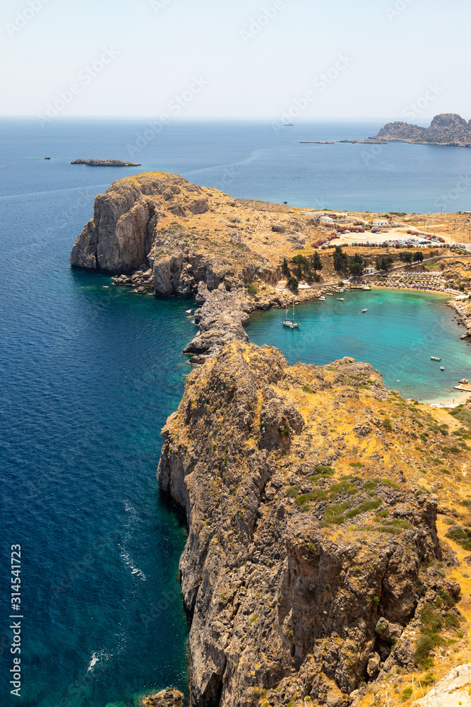Scenic view from the acropolis of Lindos at the coastline of the mediterranean sea and St. Pauls bay