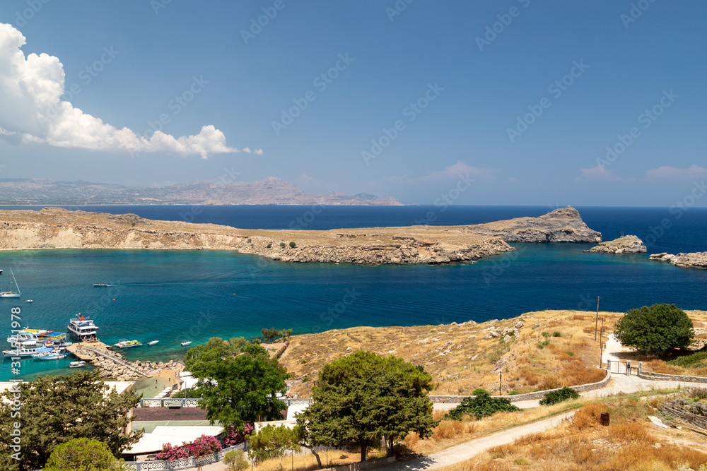 Scenic view from the acropolis on a bay with blue and turquoise water in Lindos on Rhodes island, Greece