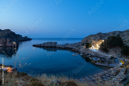 Scenic view at Saint Pauls bay in Lindos on Rhodes island, Greece during blue hour in the evening