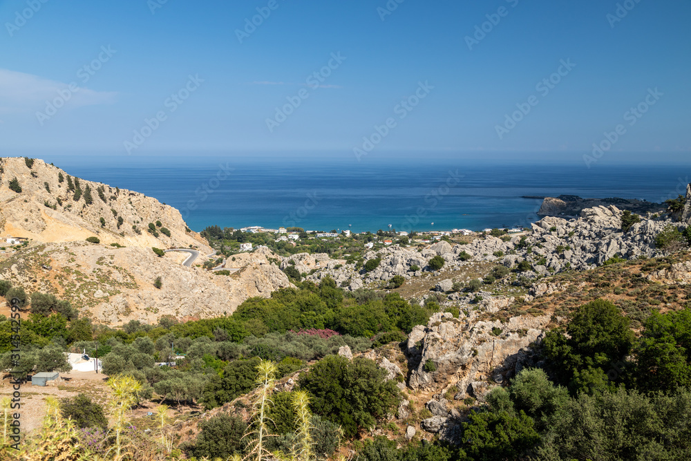 Scenic view at Stegna beach on Geek island Rhodes with rocks in the foreground and the mediterranean sea in the background