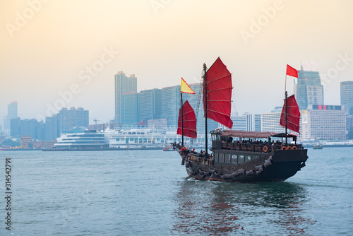 Photography Traditional wooden sailboat sails on in Victoria harbor,Hong Kong