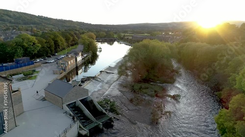 Aerial drone ascent over River Wharfe weir Otley photo