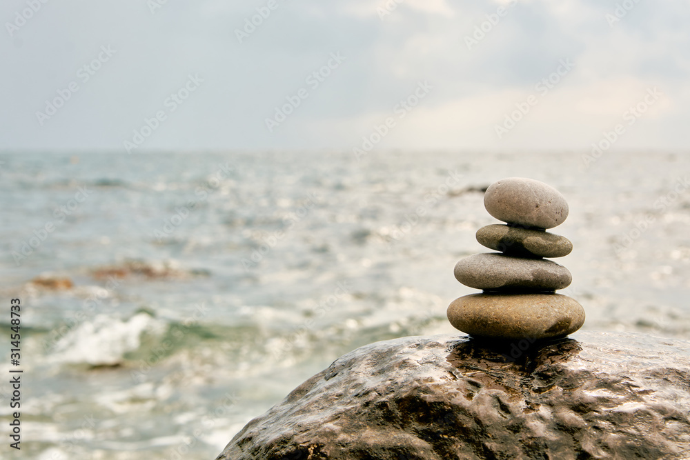 Fototapeta premium Balance, peace of mind, different sizes stones form a pyramid.