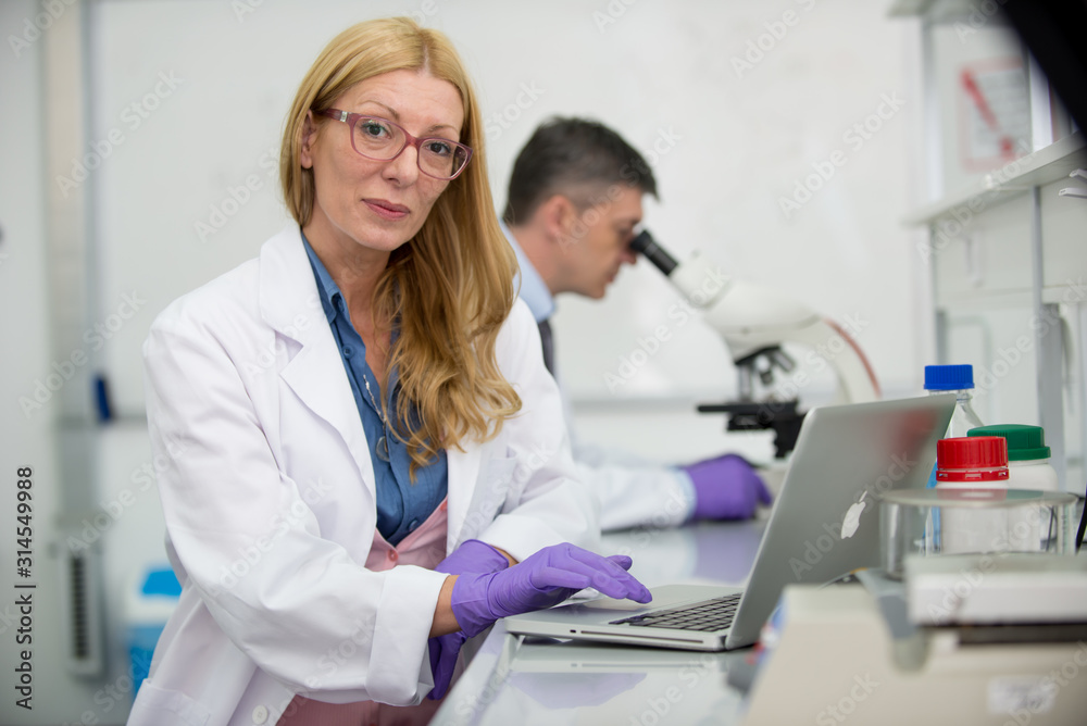 Laboratory scientists researching chemical compositions Laboratory scientists researching chemical compositions