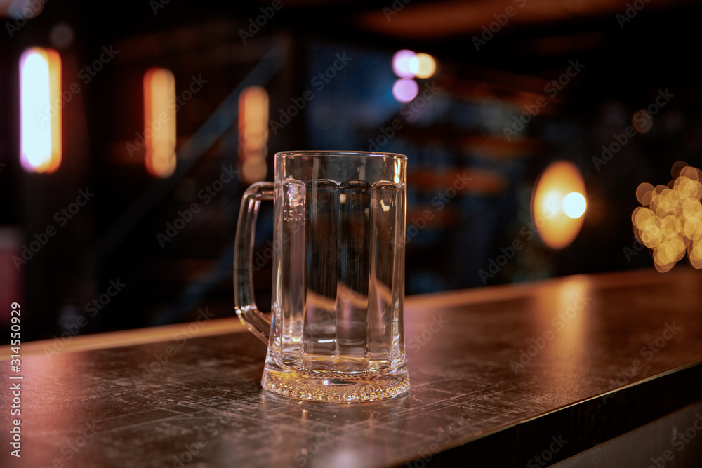 Empty pint lager on wooden table. Copy space