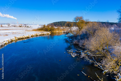 River flows in countryside near forest. Spring landscape. Bright day concept