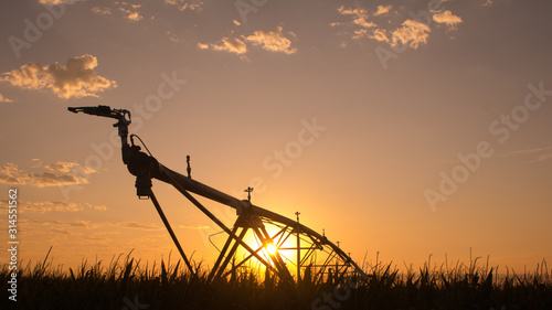 Pivot irrigation system in corn field with beautiful sunset - Nebraska USA