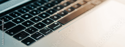 New Apple Macbook Pro on the wooden close up background banner.