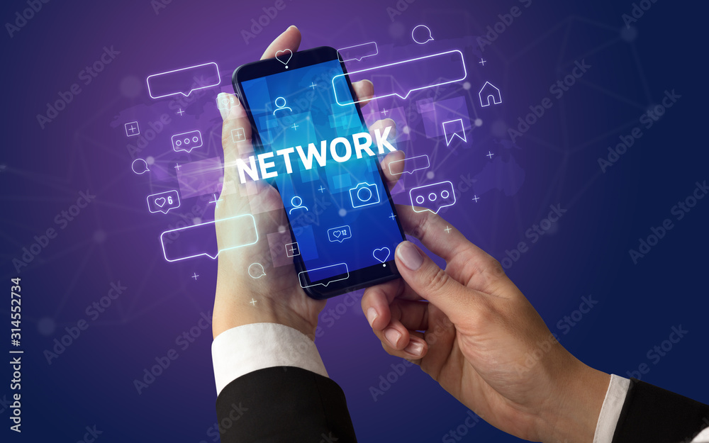 Female hand typing on smartphone with NETWORK inscription, social media concept Female hand typing on smartphone with NETWORK inscription, social media concept