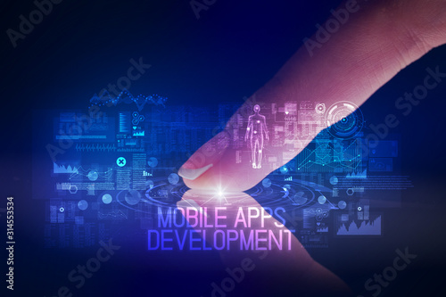 Finger touching tablet with web technology icons and MOBILE APPS DEVELOPMENT inscription
