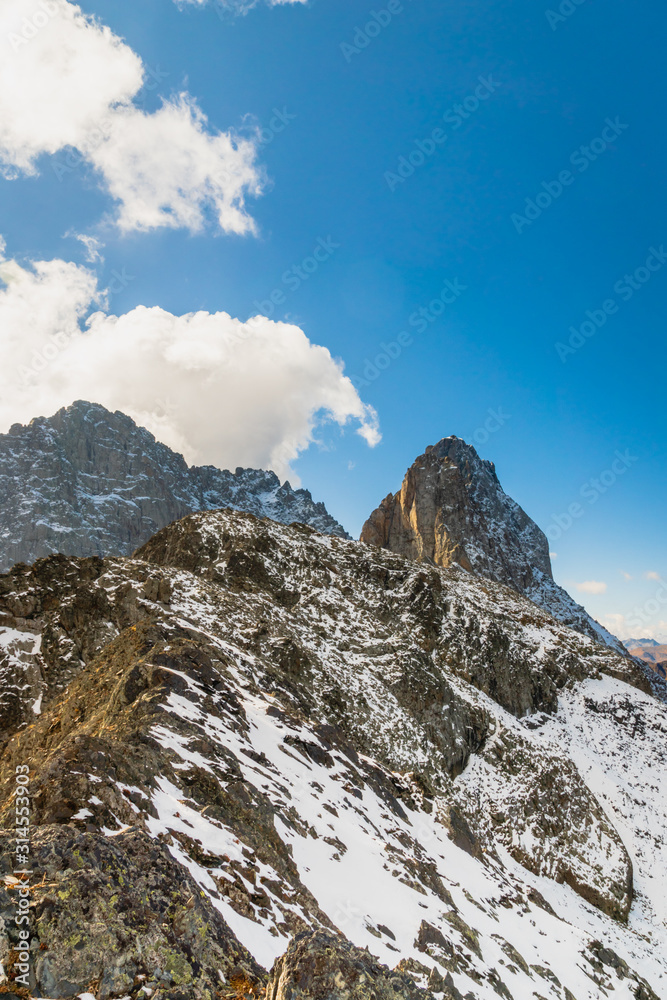 dramatic mountain landscape in Juta trekking area landscape with snowy  mountains in sunny autumn day -  popular trekking  in the Caucasus mountains, Kazbegi region, Georgia.
