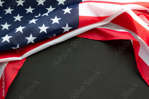 Valokuvatapetti Flag of USA on black background with copy space