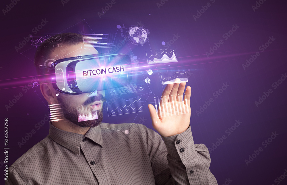 Businessman looking through Virtual Reality glasses with BITCOIN CASH inscription, new business concept Businessman looking through Virtual Reality glasses with BITCOIN CASH inscription, new business concept