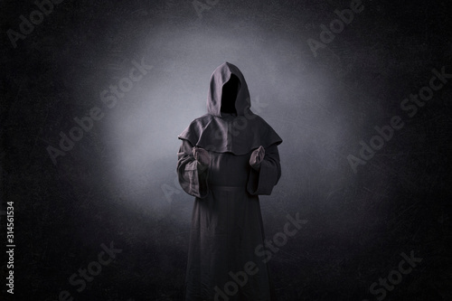 Ghostly figure with open hands in the dark photo