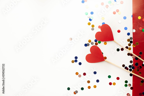Happy postcard Valentine's day, hearts on white and red background, top view with place for congratulations