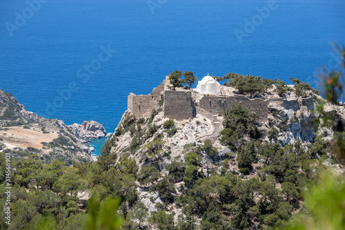 Scenic view at landscape and coastline near Monolithos on Greek island Rhodes with the aegaen sea in the background and old ruins with church on a hill