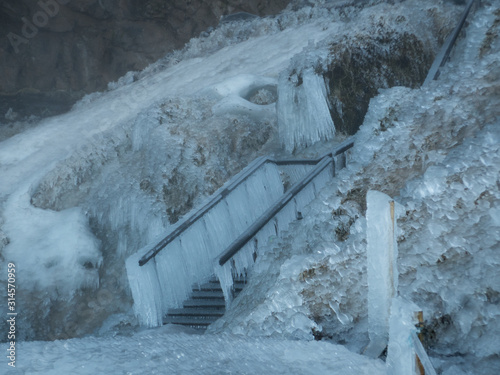 Completely frozen stairs with thick icicle near Seljalandsfoss waterfall in Iceland