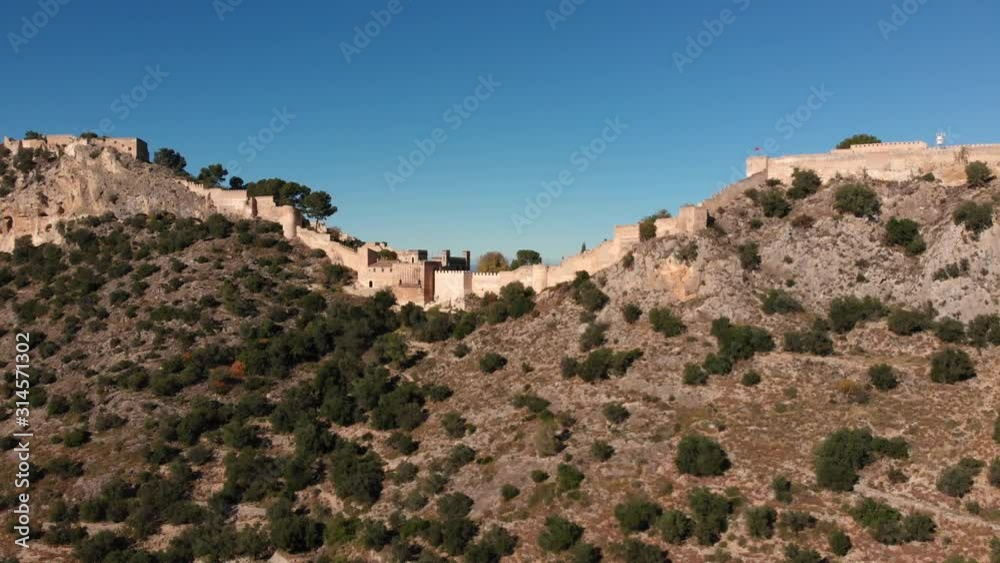 Aerial panoramic pan from an angle of an old medieval castle from afar full castle Aerial panoramic pan from an angle of an old medieval castle from afar full castle
