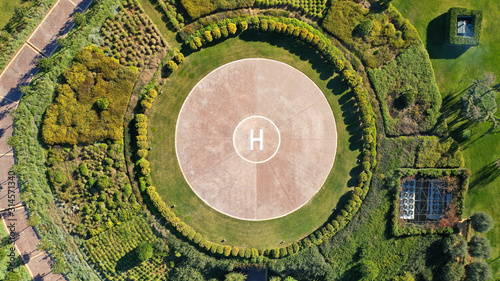 Aerial drone photo of helipad as seen in garden of Mediterranean park