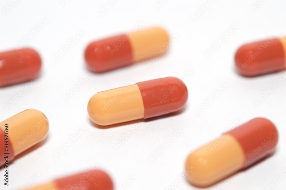 Red and orange capsules isolated on white background Red and orange capsules isolated on white background