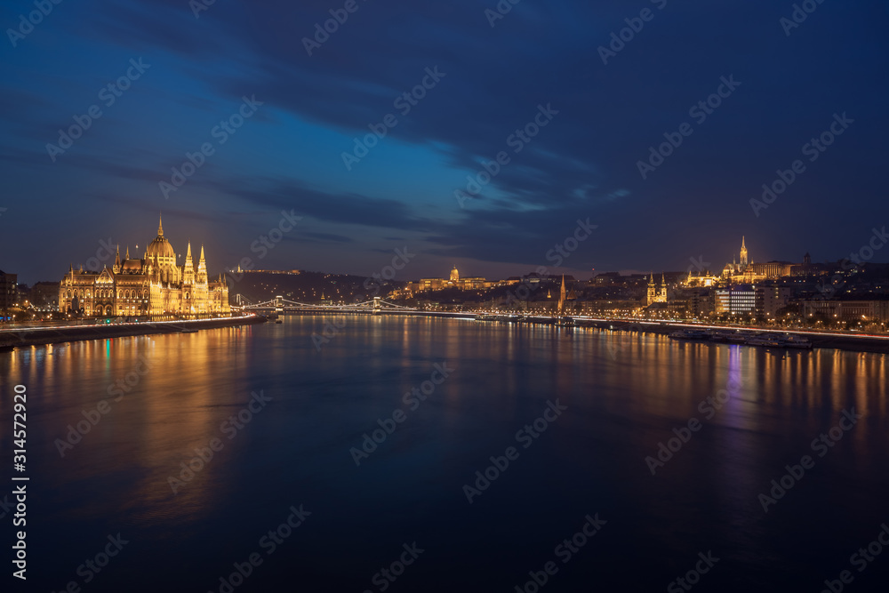 Incredible Evening View of Budapest parliament and Danube river at sunset, Hungary. Wonderful Cityscape with Colorful sky.