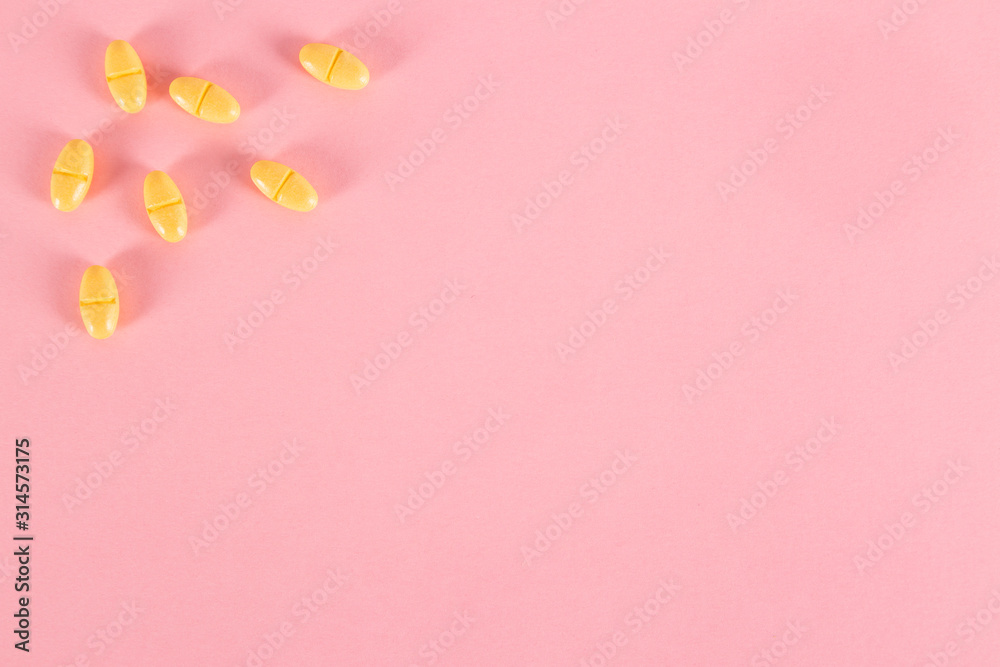 Medicine pills on pink background