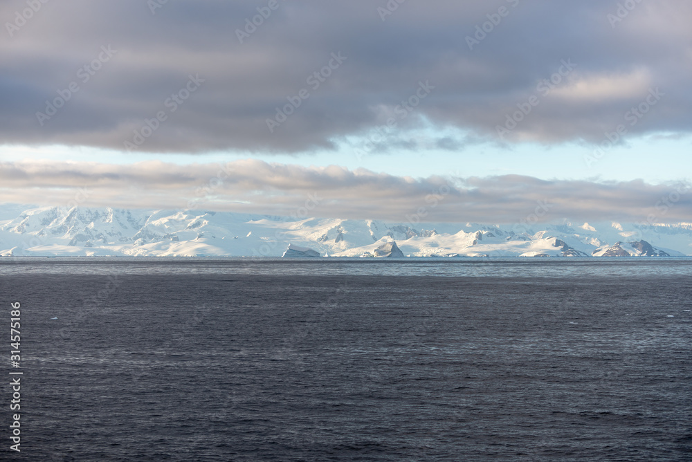 Antarctic landscape with iceberg at sea