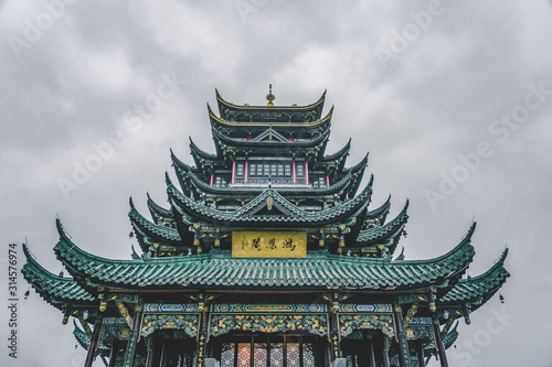 Ancient Hong'En Temple pagoda tower with green tile under overcast weather in Chongqing, Southwest China metropolis