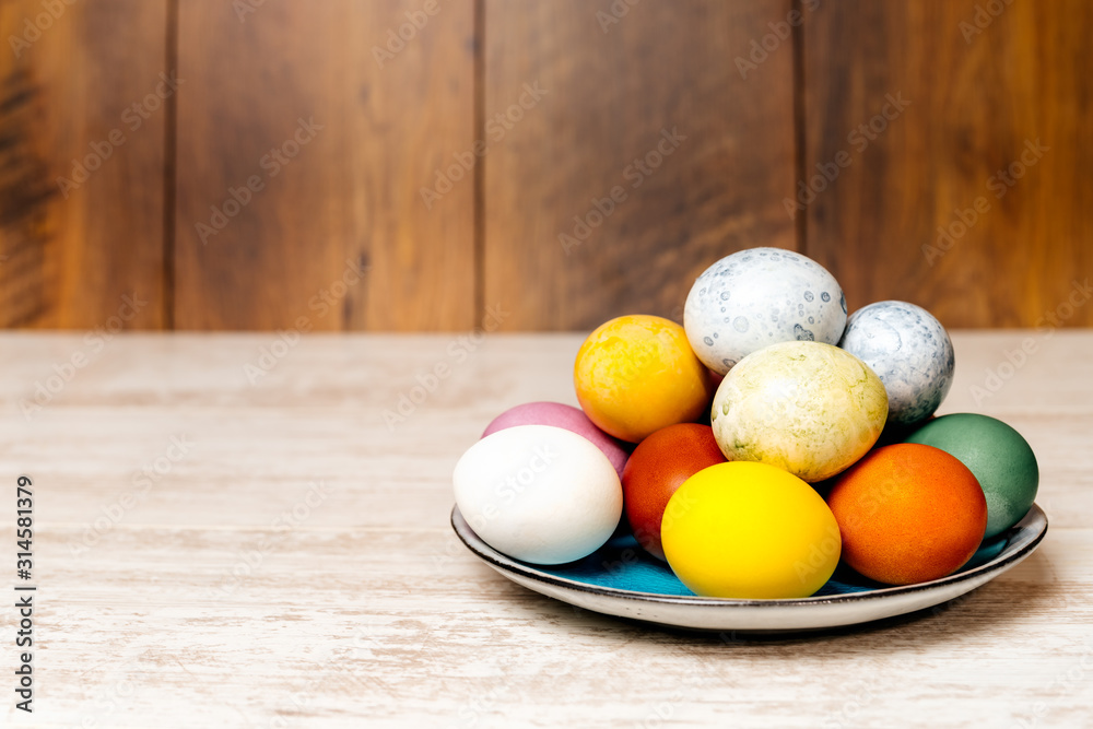 Plate full of multi coloured and mottled Easter eggs Plate full of multi coloured and mottled Easter eggs