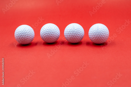 Golf balls are on red background