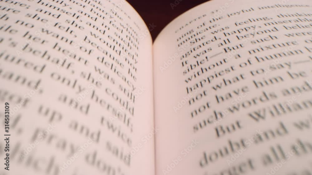 Moving fast over the middle of an open book at low angle 4K Moving fast over the middle of an open book at low angle 4K
