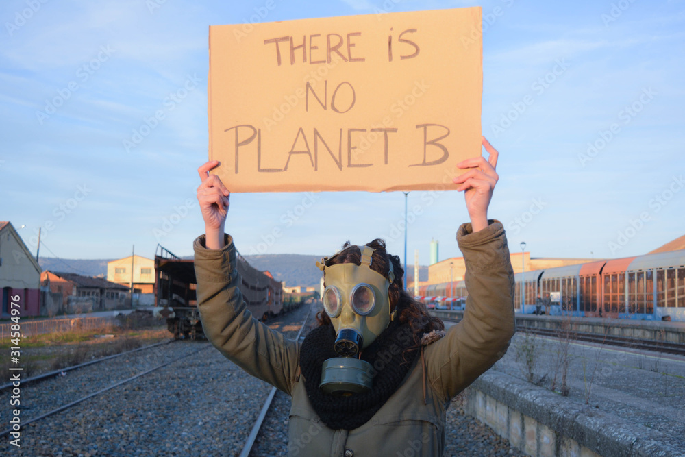 Girl with gas mask in an apocalyptic landscape and with a banner that says:  there is no planet b. Concept: ecological disaster, environmental crisis  Stock Photo | Adobe Stock