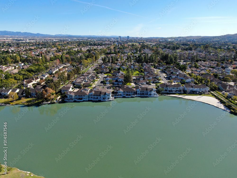 Aerial view of North Lake surrounded by residential neighborhood during blue sky day in Irvine, Orange County, USA