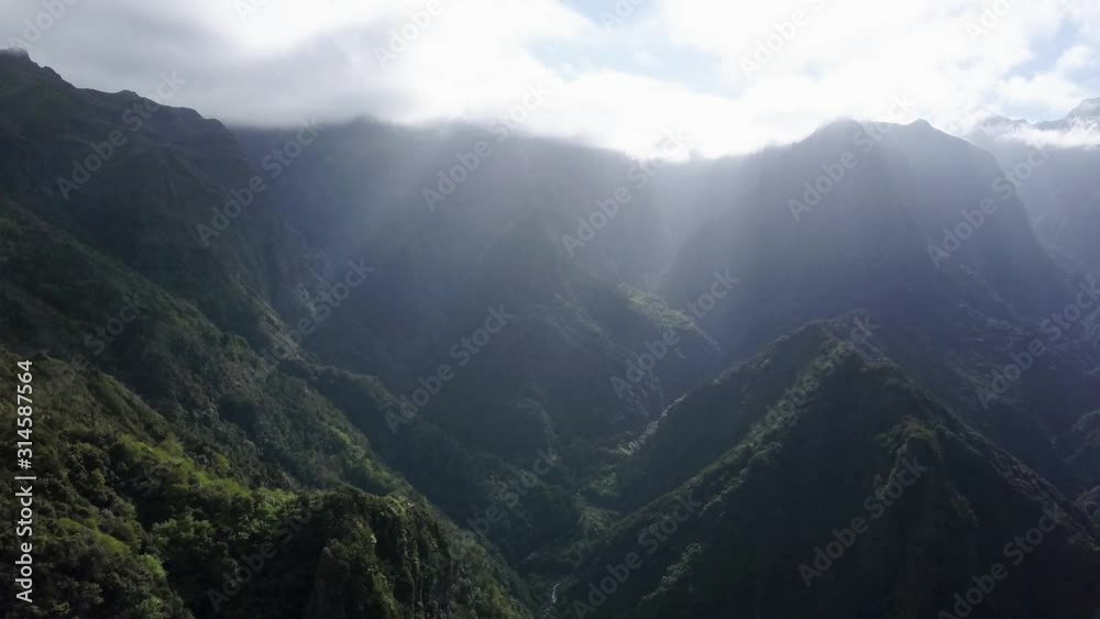 Madeira, Portugal - Ray Of Sunlight Shining Down On The Lush Mountain Range - Wonderful Natural Scenery - Aerial Drone Shot Madeira, Portugal - Ray Of Sunlight Shining Down On The Lush Mountain Range - Wonderful Natural Scenery - Aerial Drone Shot