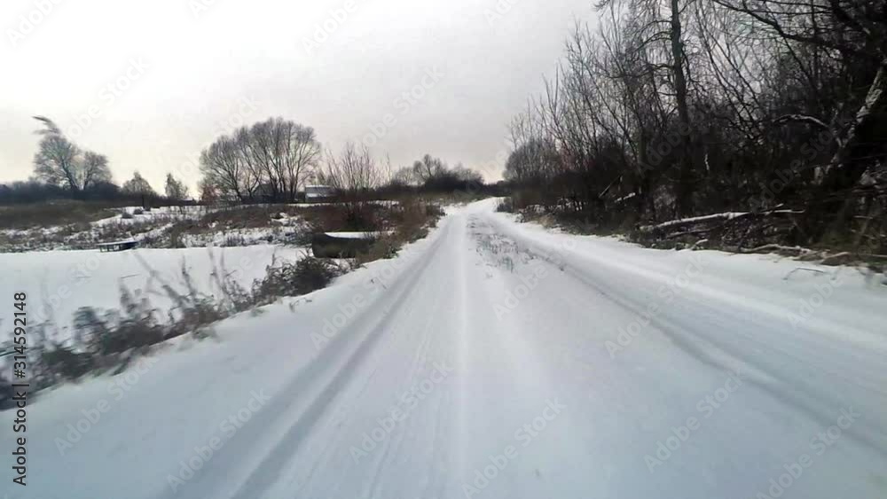 Winter road with an action camera mounted on the front bumper of an off-road car Winter road with an action camera mounted on the front bumper of an off-road car