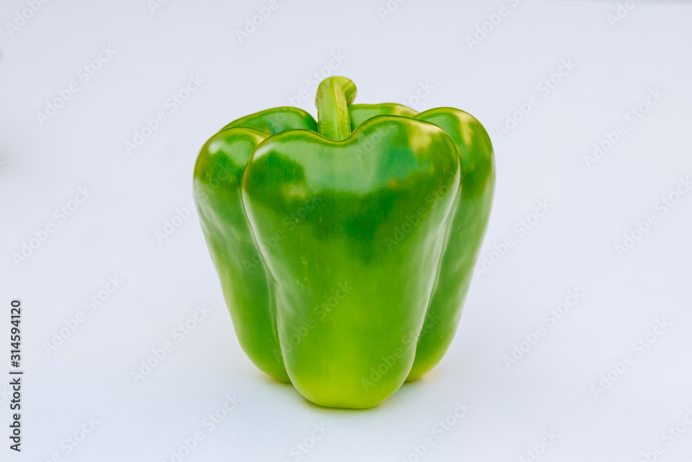 Fresh green bell pepper on a white background. Fresh green bell pepper on a white background.