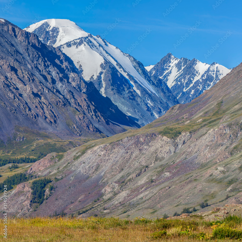 Mountain view, sunny day. Snow-capped peaks, gorge. Traveling in the mountains, climbing. Mountain view, sunny day. Snow-capped peaks, gorge. Traveling in the mountains, climbing.