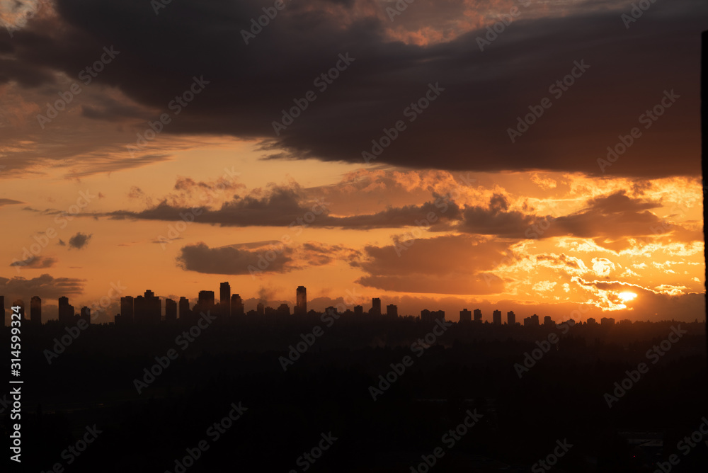 Urban area silhouette on sunset sky background.