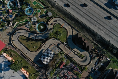 Photography Aerial View Looking Down over go kart track with cars racing