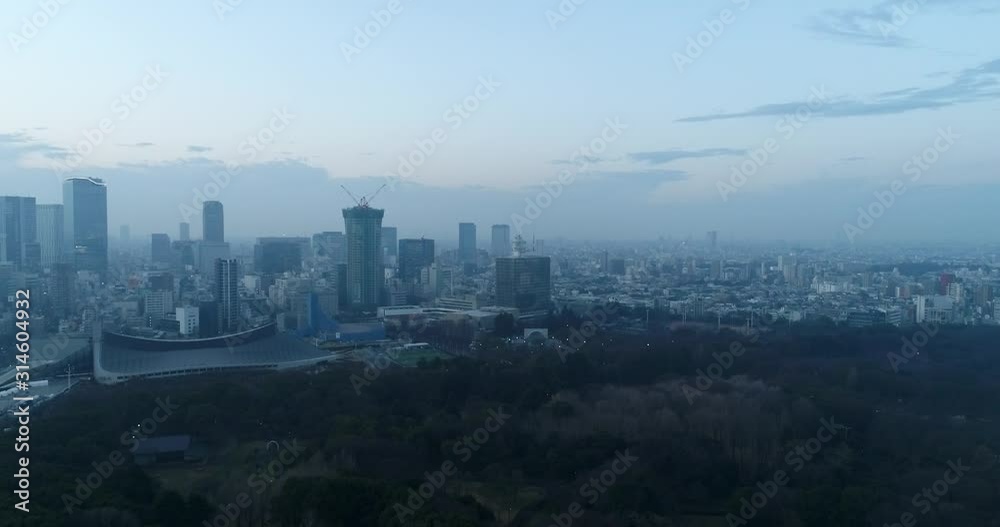 Shibuya business district of modern architecture and high-rise skyscraper towers at sunrise near green garden and park in central Tokyo, Japan. Shibuya business district of modern architecture and high-rise skyscraper towers at sunrise near green garden and park in central Tokyo, Japan.