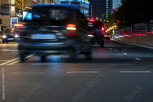 Fototapeta Naklejka Na Ścianę i Meble -  car traffic at city road during rush hours. blurred car lights. motion blur