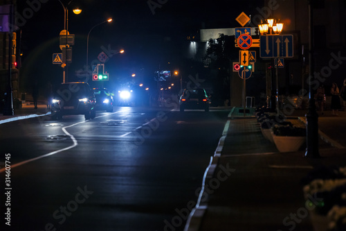 view of city night road with cars standing on crossroad. car lights shining bright © Mr Twister