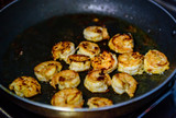 Process of roasting fresh shrimp without shell, selective focus. Peeled king prawns in a pan, close-up. Seafood, a source of protein.